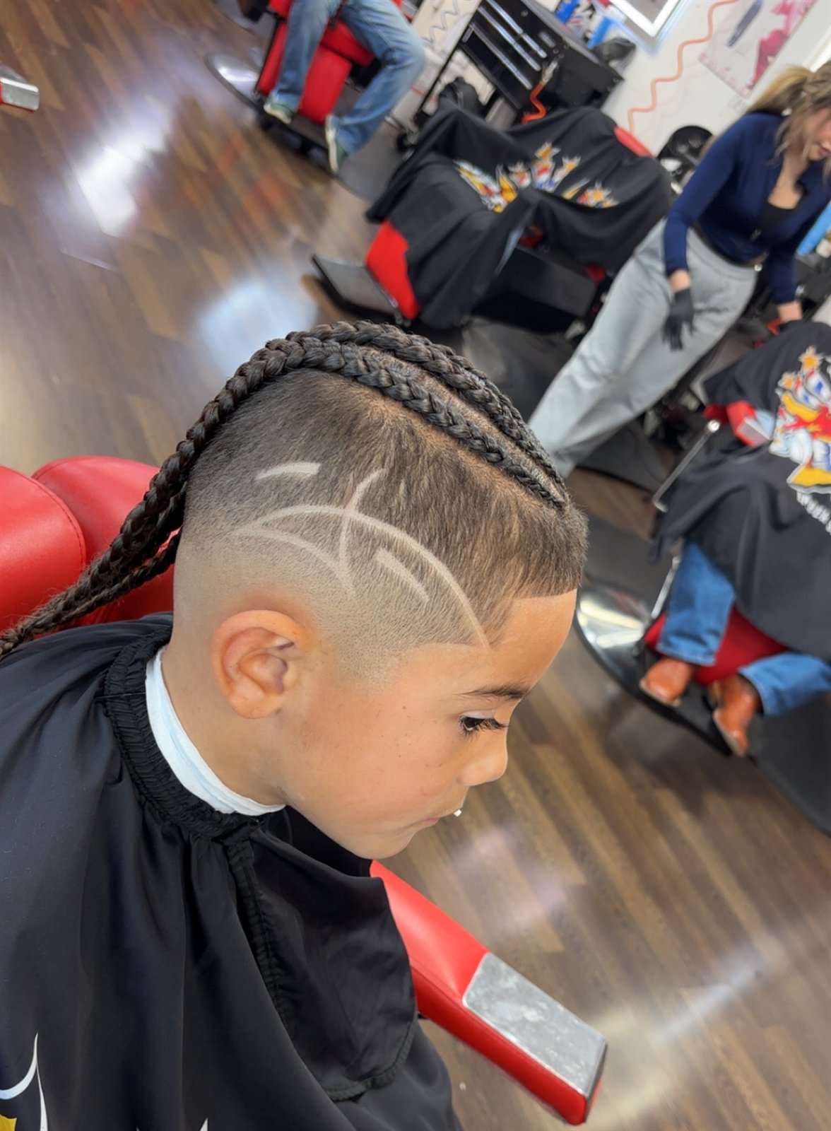 Kid's braids with a freehand carved hair design